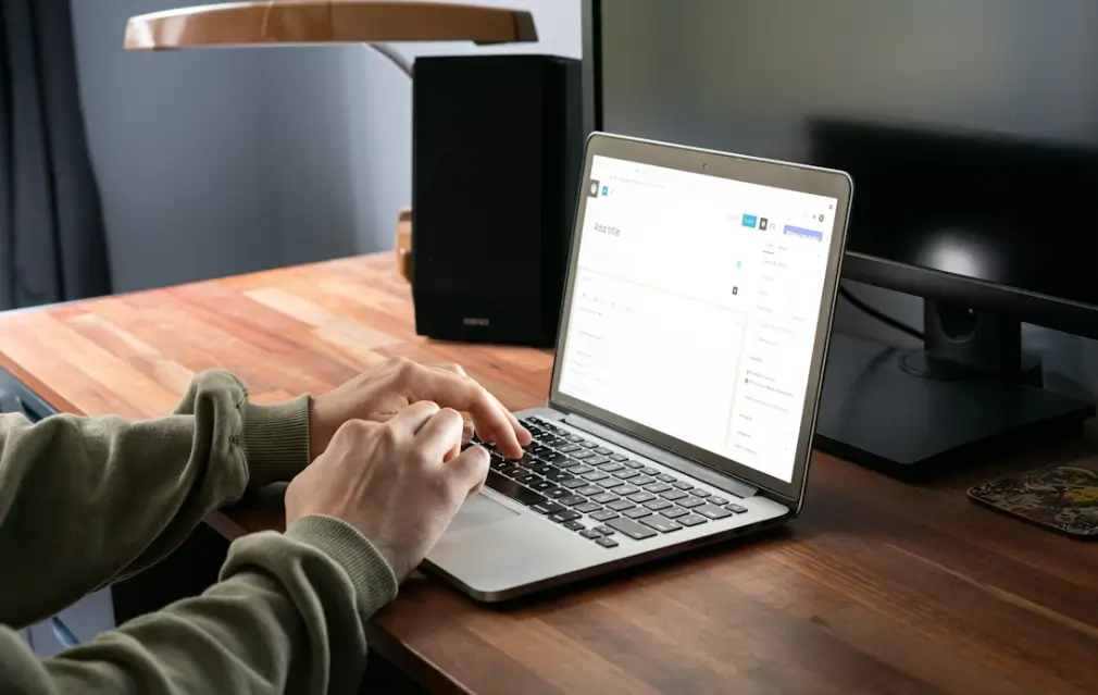 bras d'une personne travaillant devant sont laptop sur article WordPress